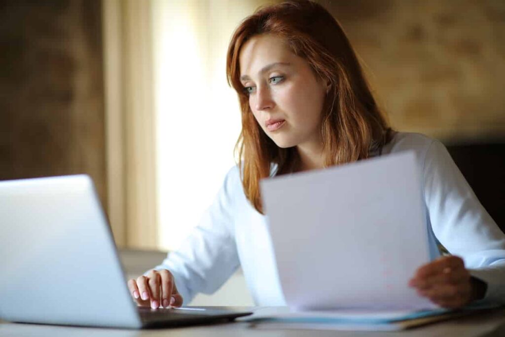 A woman reviews inventory on a balance sheet