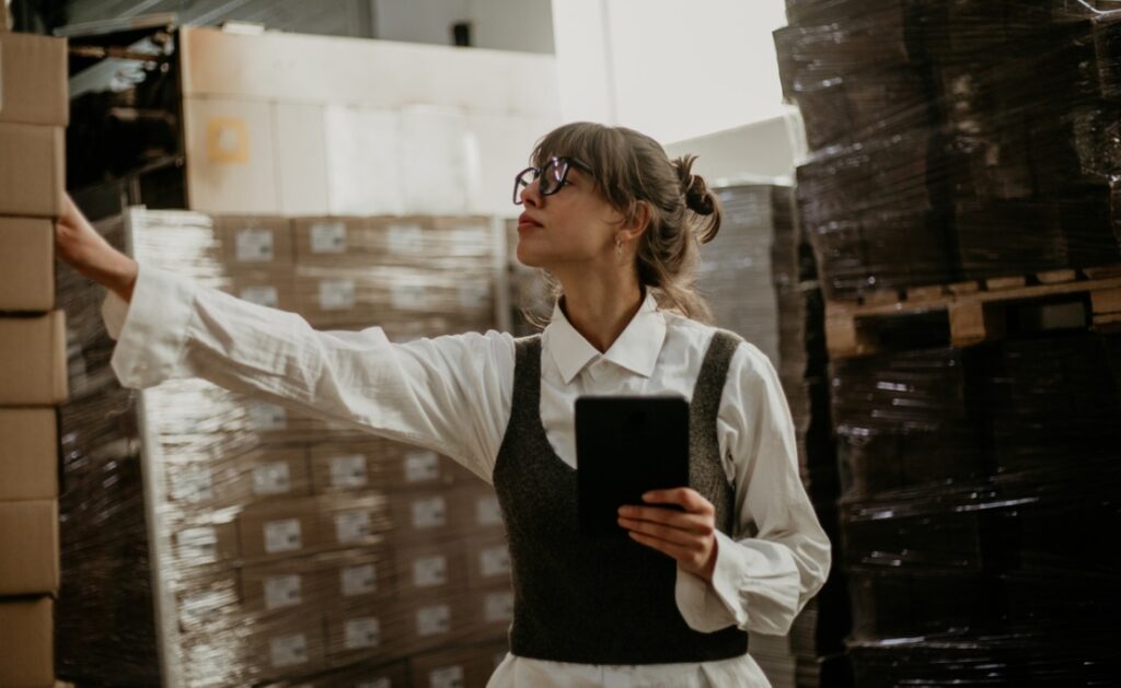 A woman analyzing surplus inventory.