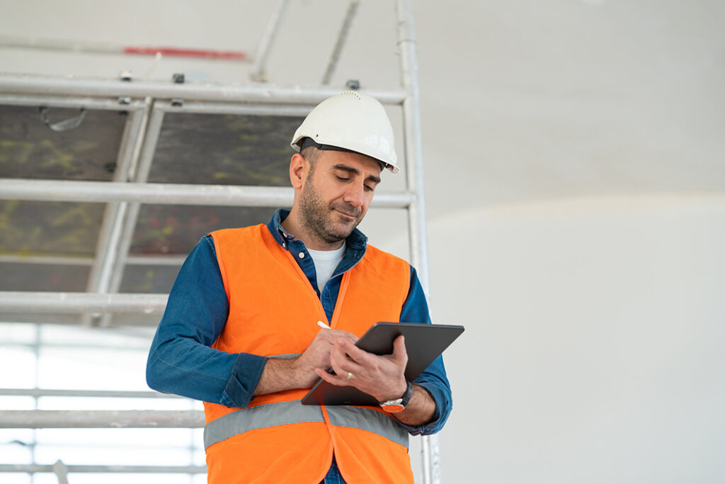 man managing construction inventory on a tablet